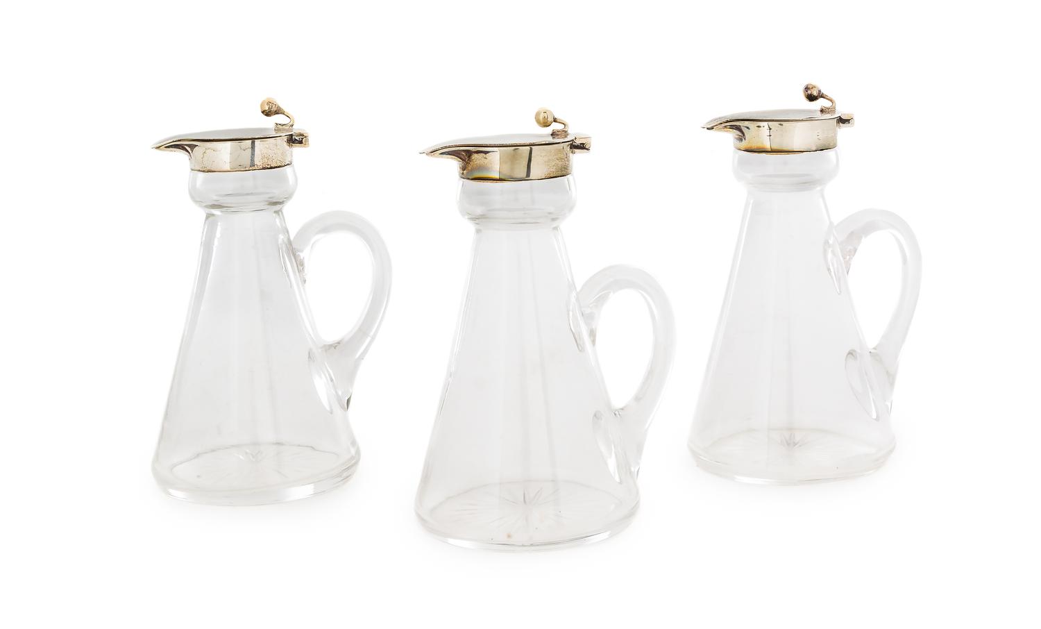 A Set of Three Edwardian Silver-Mounted Glass Cruets, H. B. Johnson & Co., Birmingham, 1910, the silver collar and spout with a globula