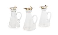 A Set of Three Edwardian Silver-Mounted Glass Cruets, H. B. Johnson & Co., Birmingham, 1910, the silver collar and spout with a globula