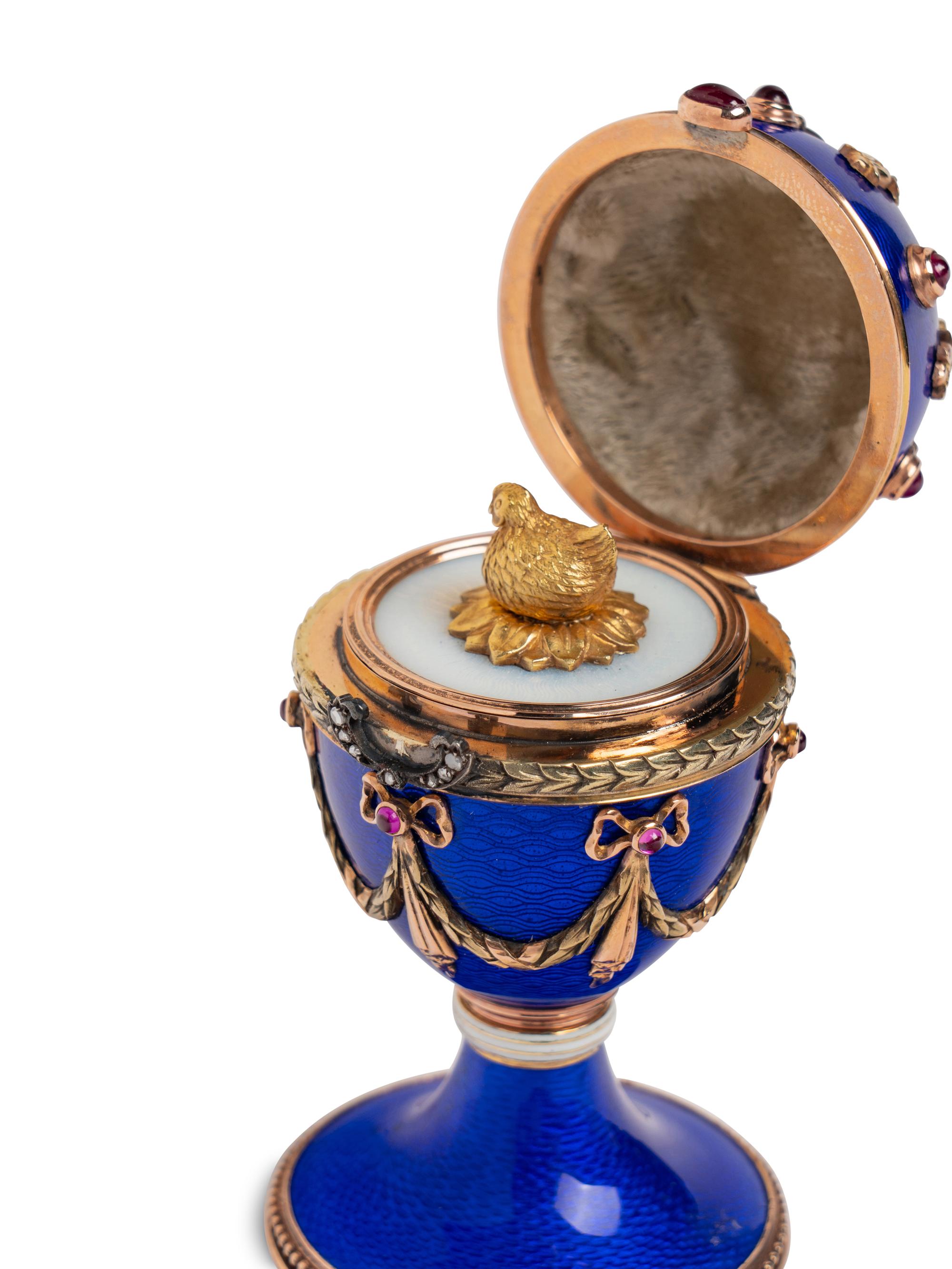 A 14 Karat Vari-Color Gold, Guilloché Enamel, Diamond, and Cabochon Jewel-Mounted Egg-Form Perfume and a Related Guilloché Enamel, 14 Karat Vari-Color Gold, Diamond, and Cabochon-Mounted Surprise Egg