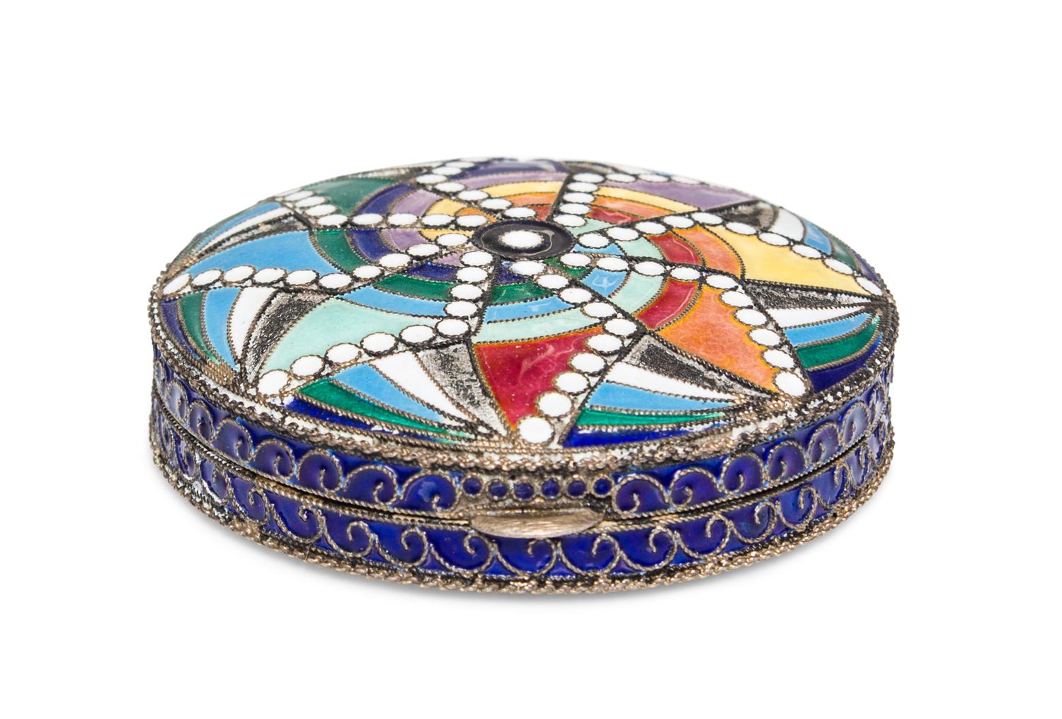 A Soviet Art Deco Enameled Slver Compact, St. Petersburg, 20th Century, of circular form with polychrome geometric decoration.