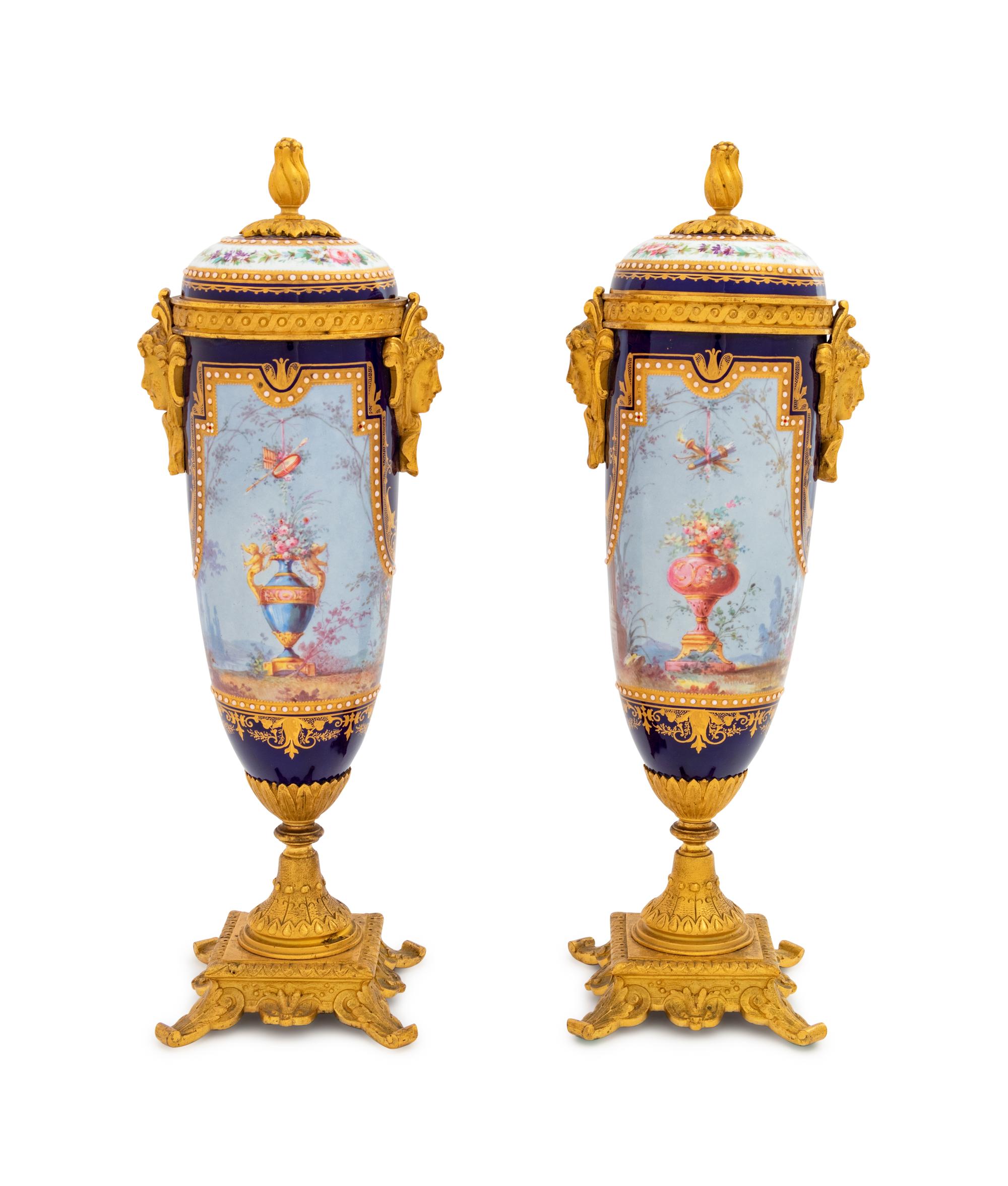A Pair of Sèvres Style Gilt Bronze Mounted Painted, Parcel Gilt and "Jeweled" Porcelain Urns