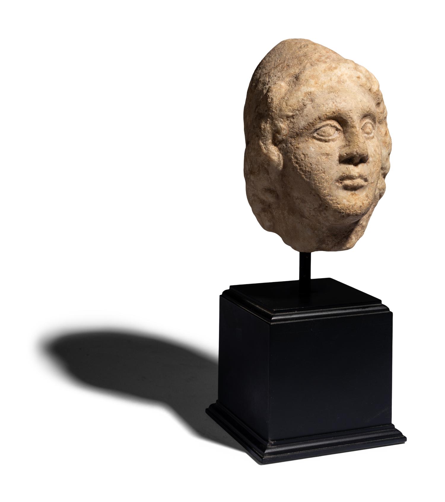 A Roman Marble Head of a Man Wearing a Phyrigian Cap