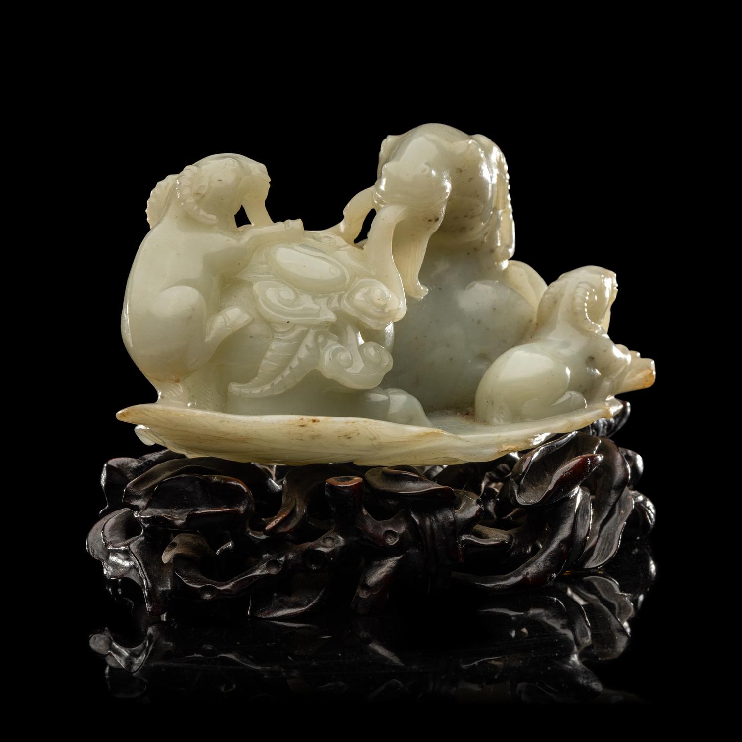 A Chinese Pale Celadon Jade 'Three Rams' Carving 青白玉三羊開泰