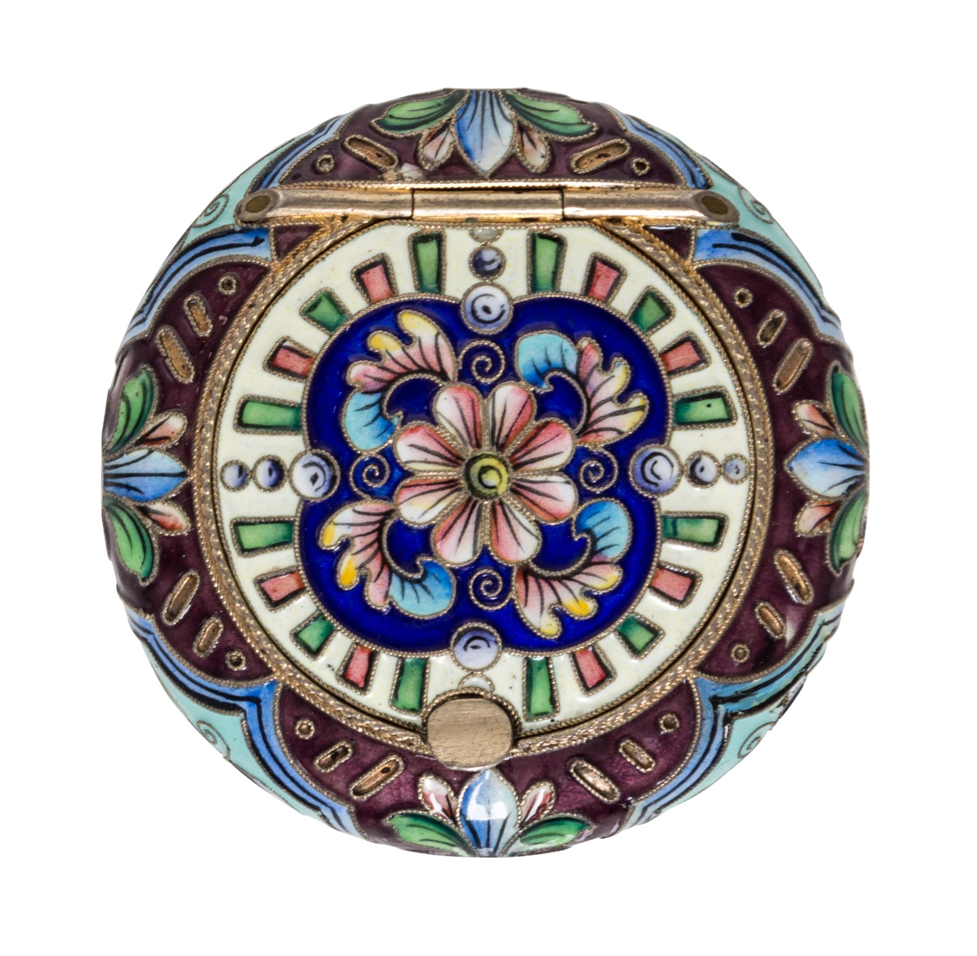 A Russian Enameled Gilt-Silver Pill Box, 6th Artel, Moscow, 1908-1926, of circular form with polychrome floral decoration.