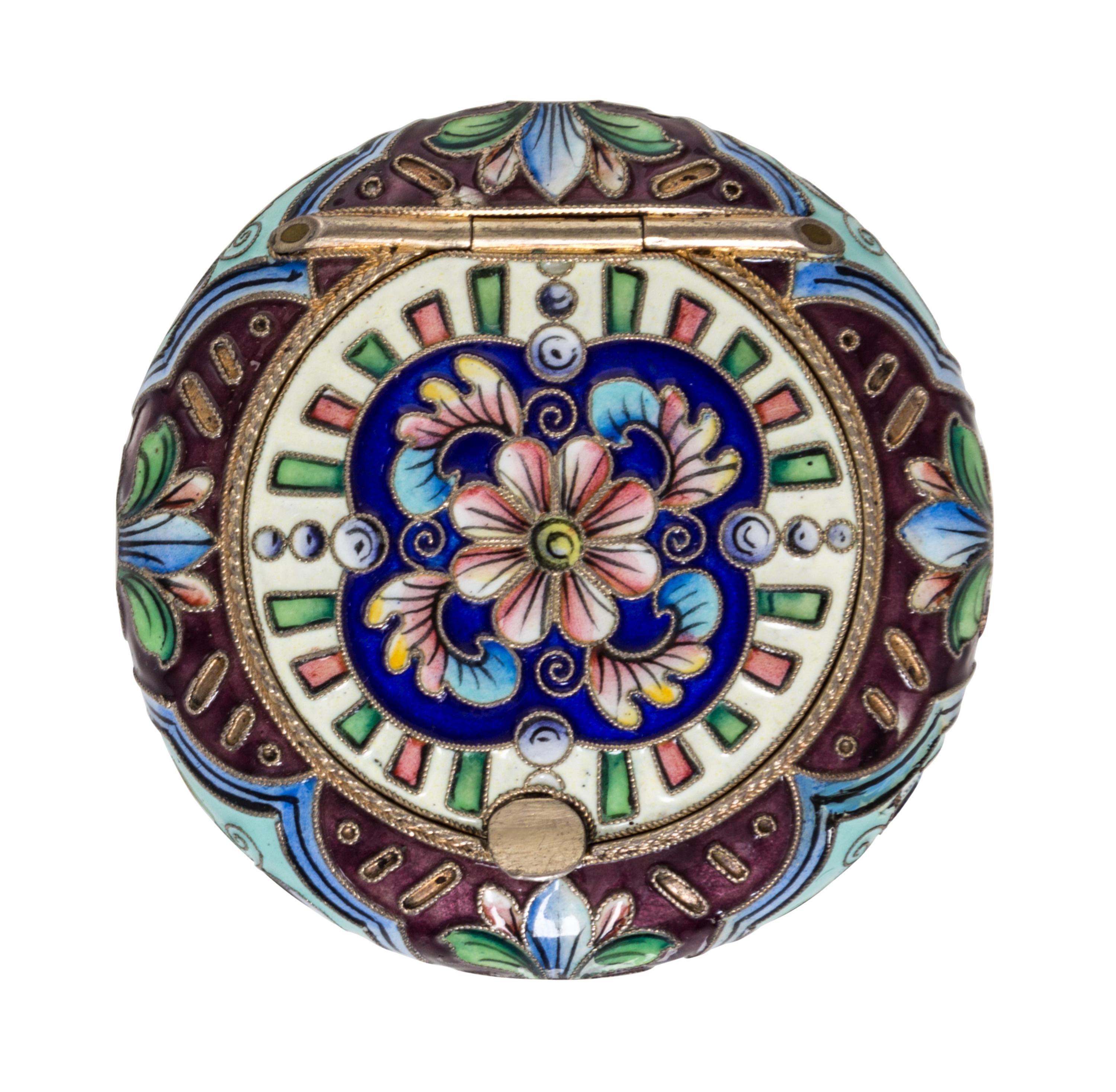 A Russian Enameled Gilt-Silver Pill Box, 6th Artel, Moscow, 1908-1926, of circular form with polychrome floral decoration.