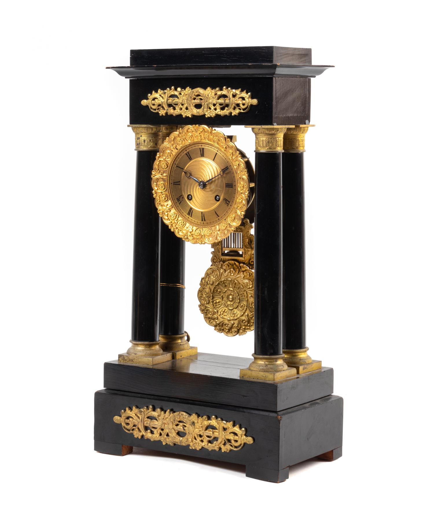 An Empire Style Gilt Metal Mounted Ebonized Mantel Clock