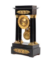 An Empire Style Gilt Metal Mounted Ebonized Mantel Clock