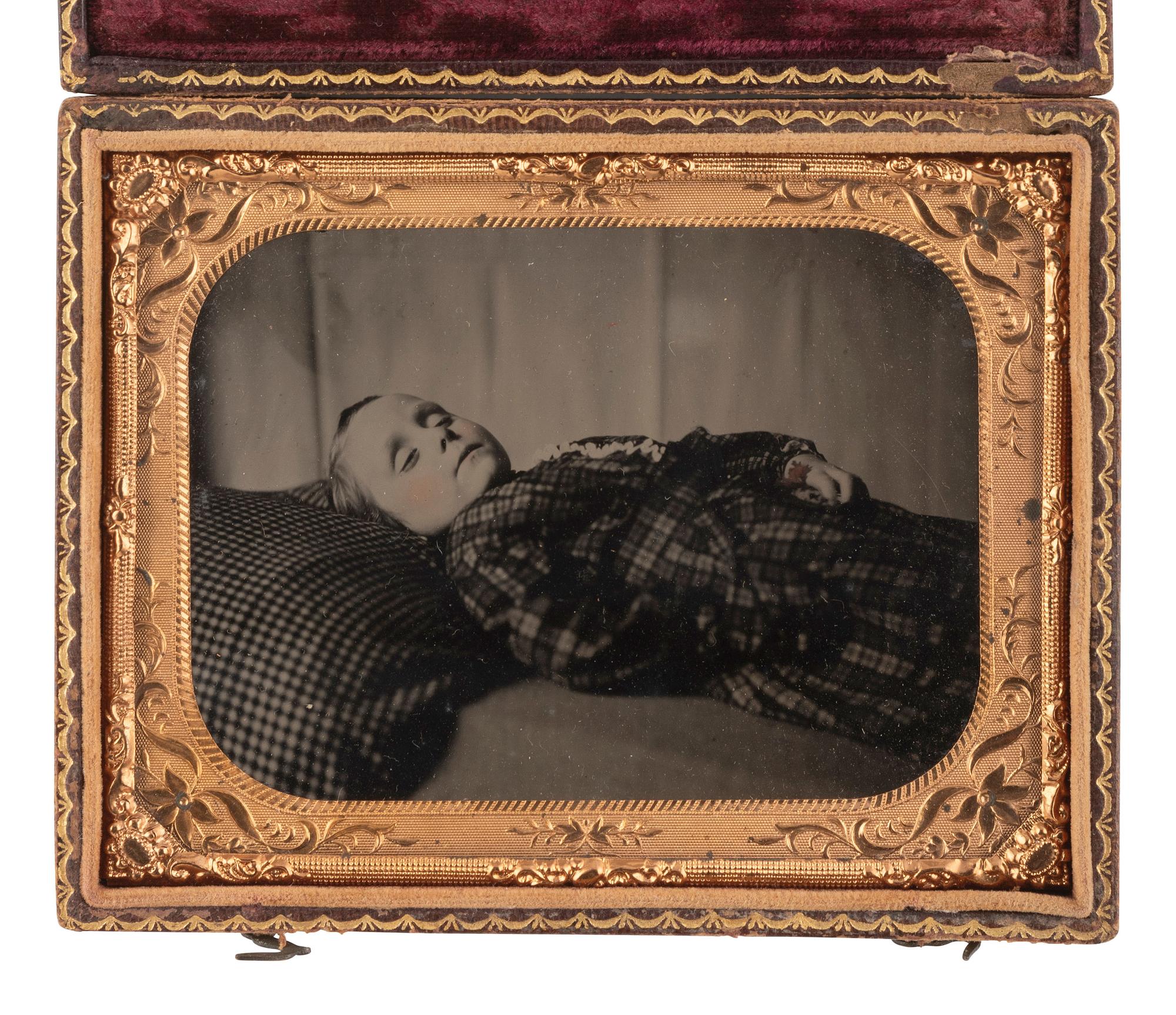 [EARLY PHOTOGRAPHY]. Quarter plate postmortem ruby ambrotype of a young child.
