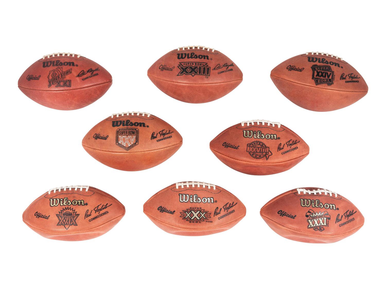 A Group of Eight Wilson Super Bowl Official Footballs and Promotional Poster,