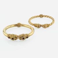 A Pair of Two Etruscan Style Bangle Bracelets