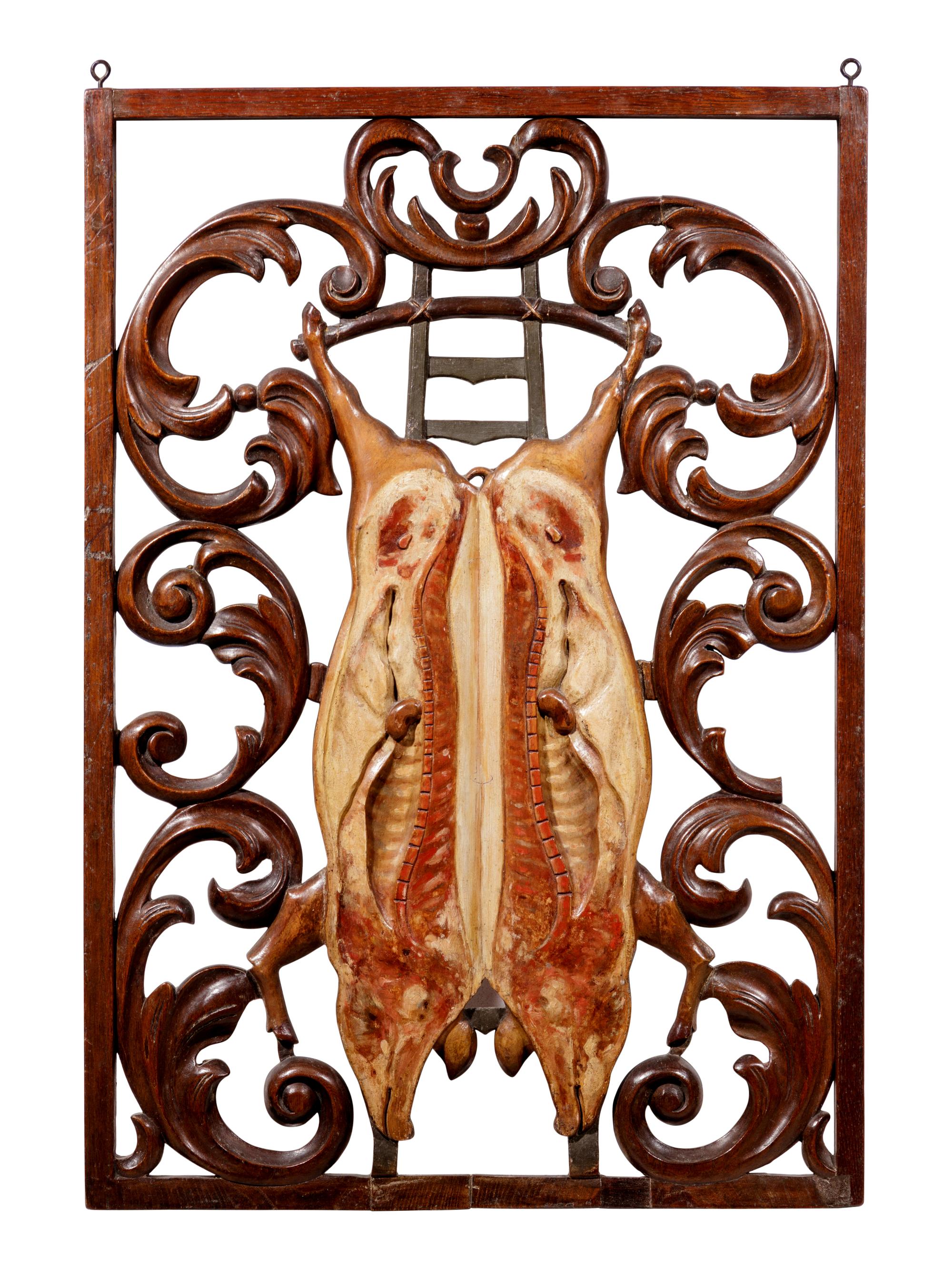 A Continental Carved and Polychrome Decorated Two Sided Butcher's Trade Sign