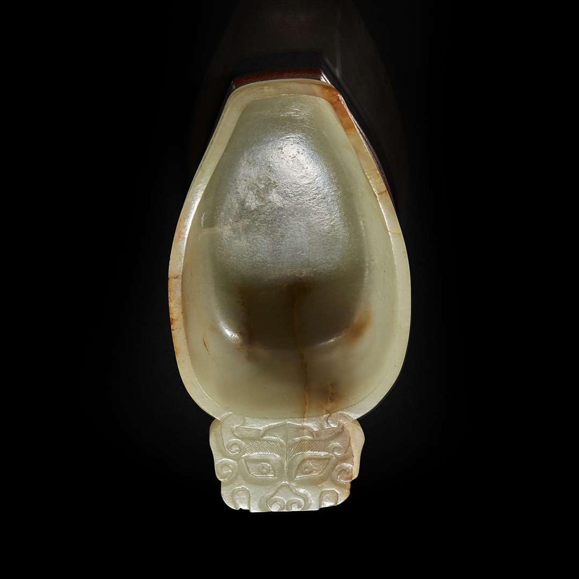 A Chinese pale celadon jade archaistic libation cup and a bronze rabbit seal 玉匜与铜兔印章一组 The jade 17th/18th Century, the seal possibly Yuan dynasty ?????????? ??????