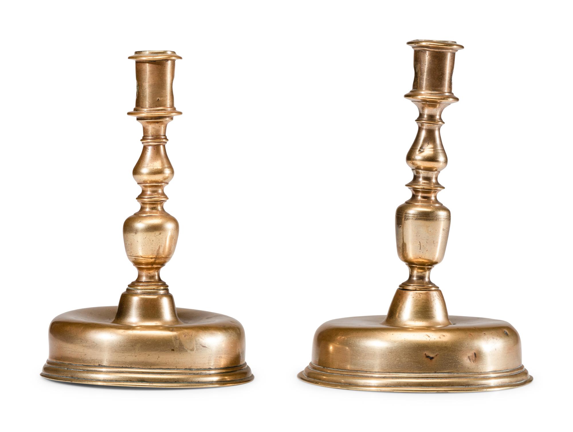 A Near Pair of Dutch William and Mary Brass Bell-Bottom Candlesticks