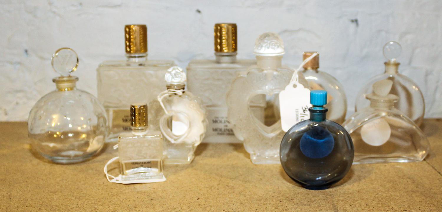 A Collection of Ten Lalique Glass Perfume Bottles. Height of tallest 4 7/8 inches.
