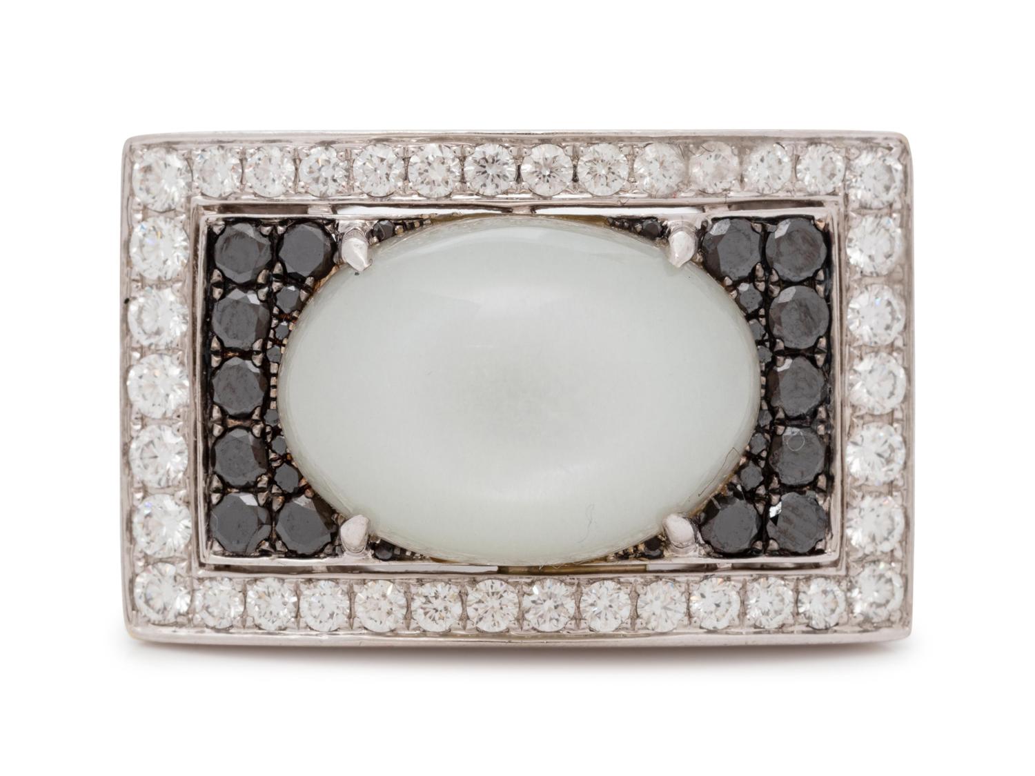 An 18 Karat White Gold, Moonstone, Black Diamond, and Diamond Ring,