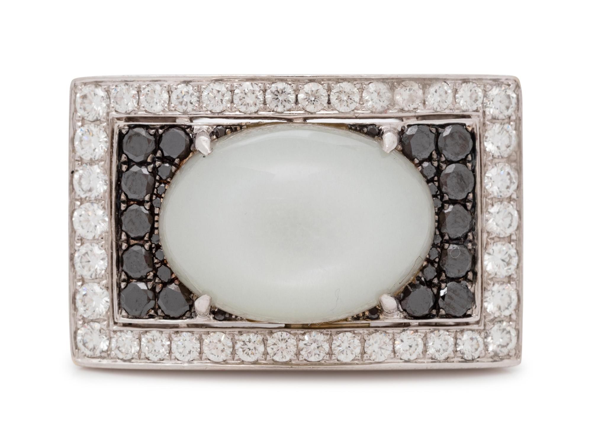 An 18 Karat White Gold, Moonstone, Black Diamond, and Diamond Ring,
