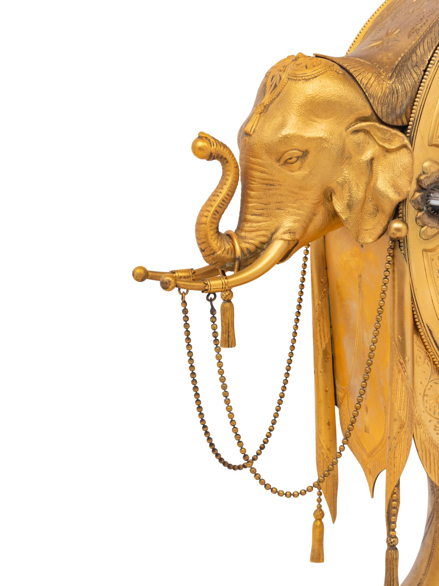 An English Orientalist Gilt Bronze Three-Piece Clock Garniture