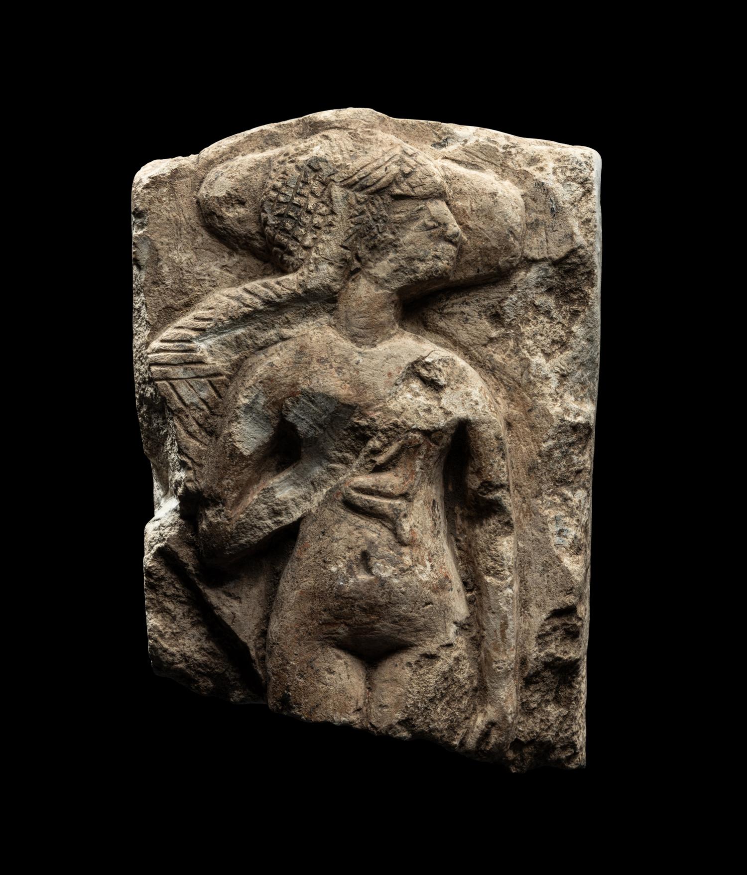 An Egyptian Limestone Fragment of a Mother Nursing her Child