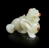 A Celadon and Russet Jade Carving of a Mythical Beast, Bixie Length 1 5/8 inches. — 18TH CENTURY