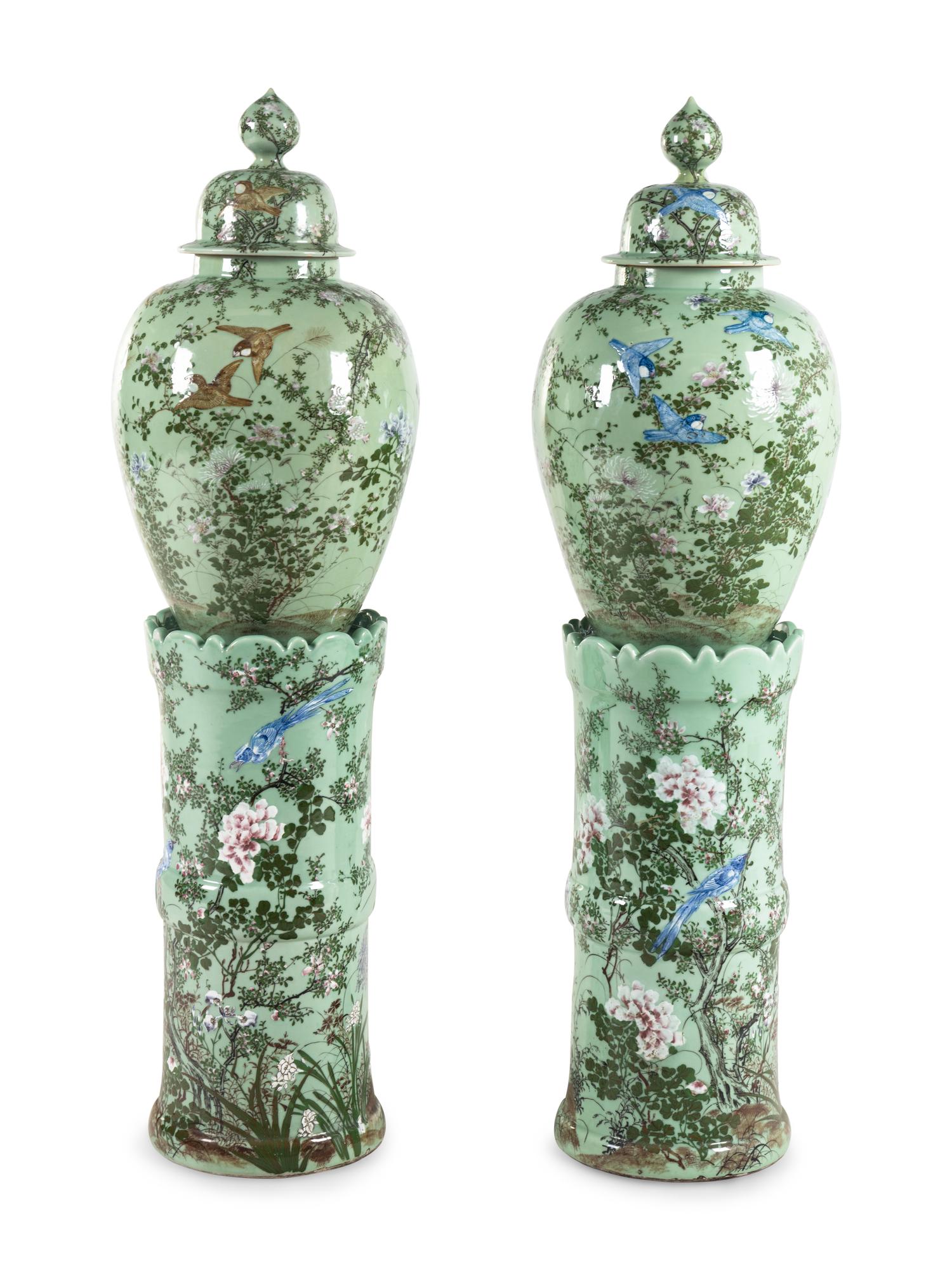 A Pair of Chinese Large Porcelain Covered Urns on Pedestals