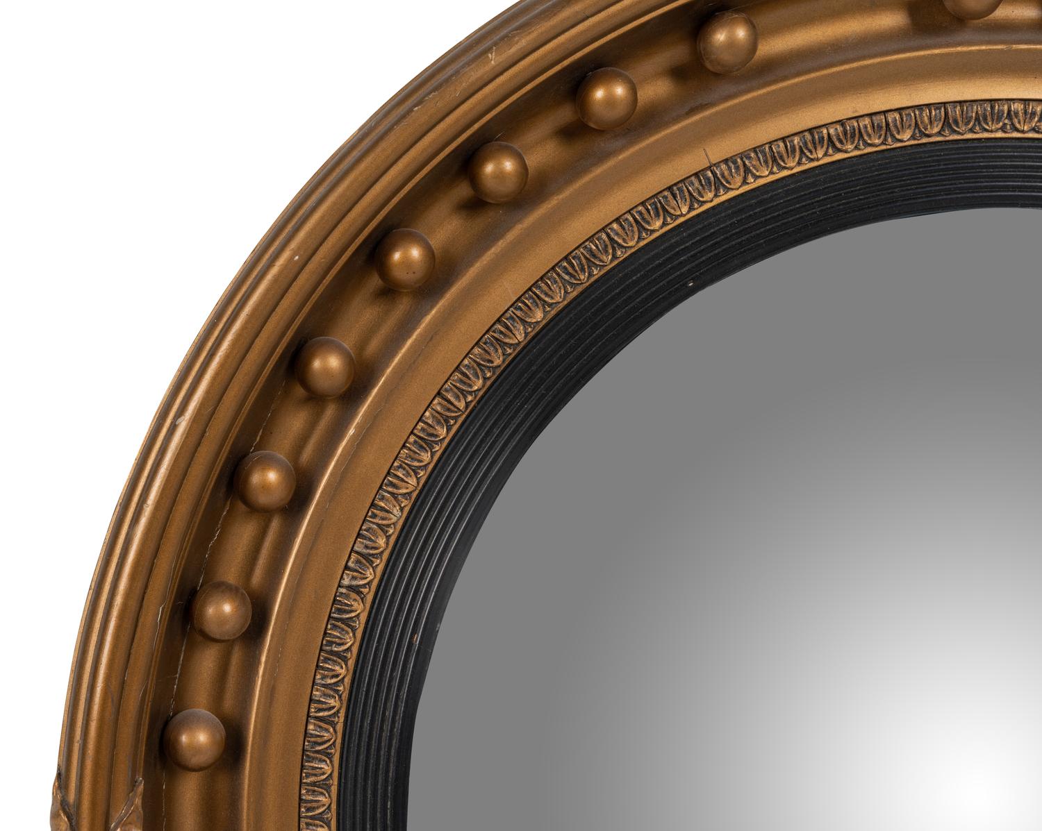 A Regency Giltwood and Ebonized Convex Mirror