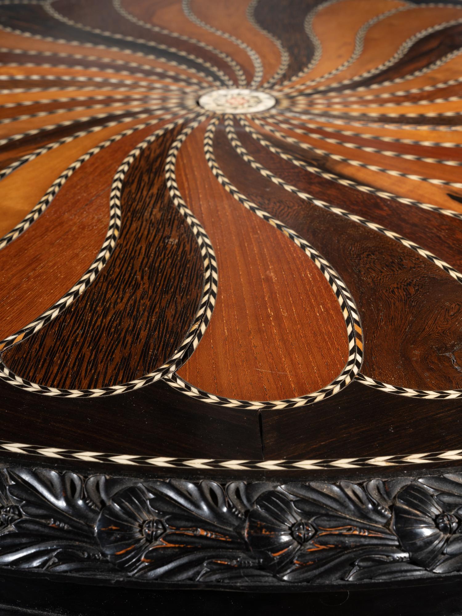 An Anglo-Colonial Carved and Specimen Woods Inlaid Tilt-Top Breakfast Table