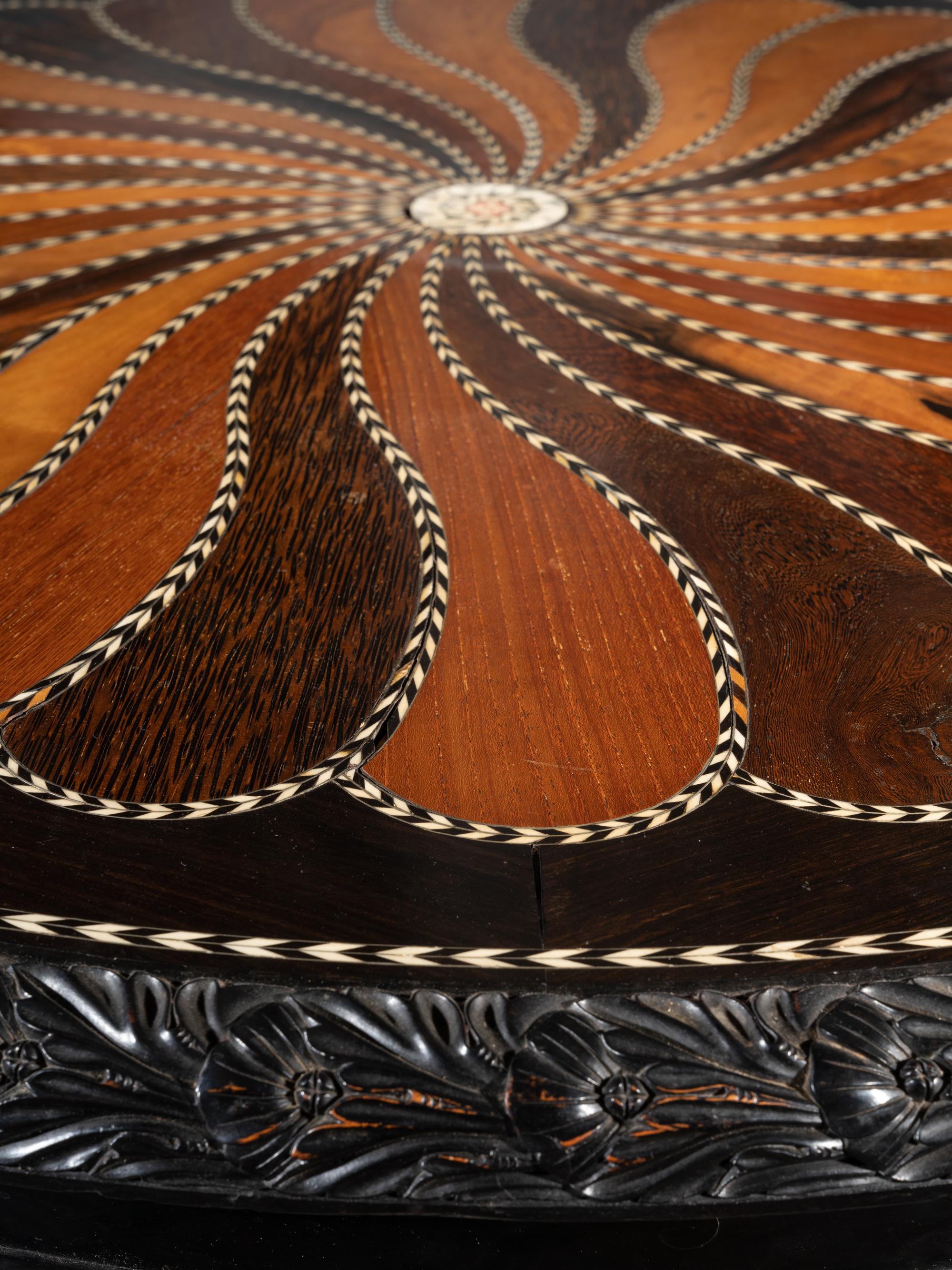 An Anglo-Colonial Carved and Specimen Woods Inlaid Tilt-Top Breakfast Table