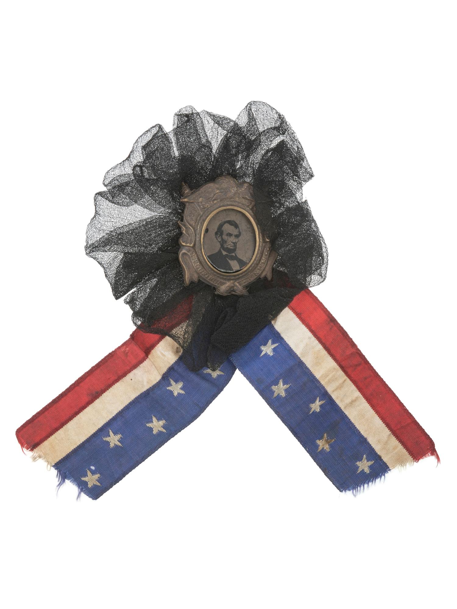[LINCOLN, Abraham (1809-1865)]. Lincoln mourning cockade with ferrotype at center.