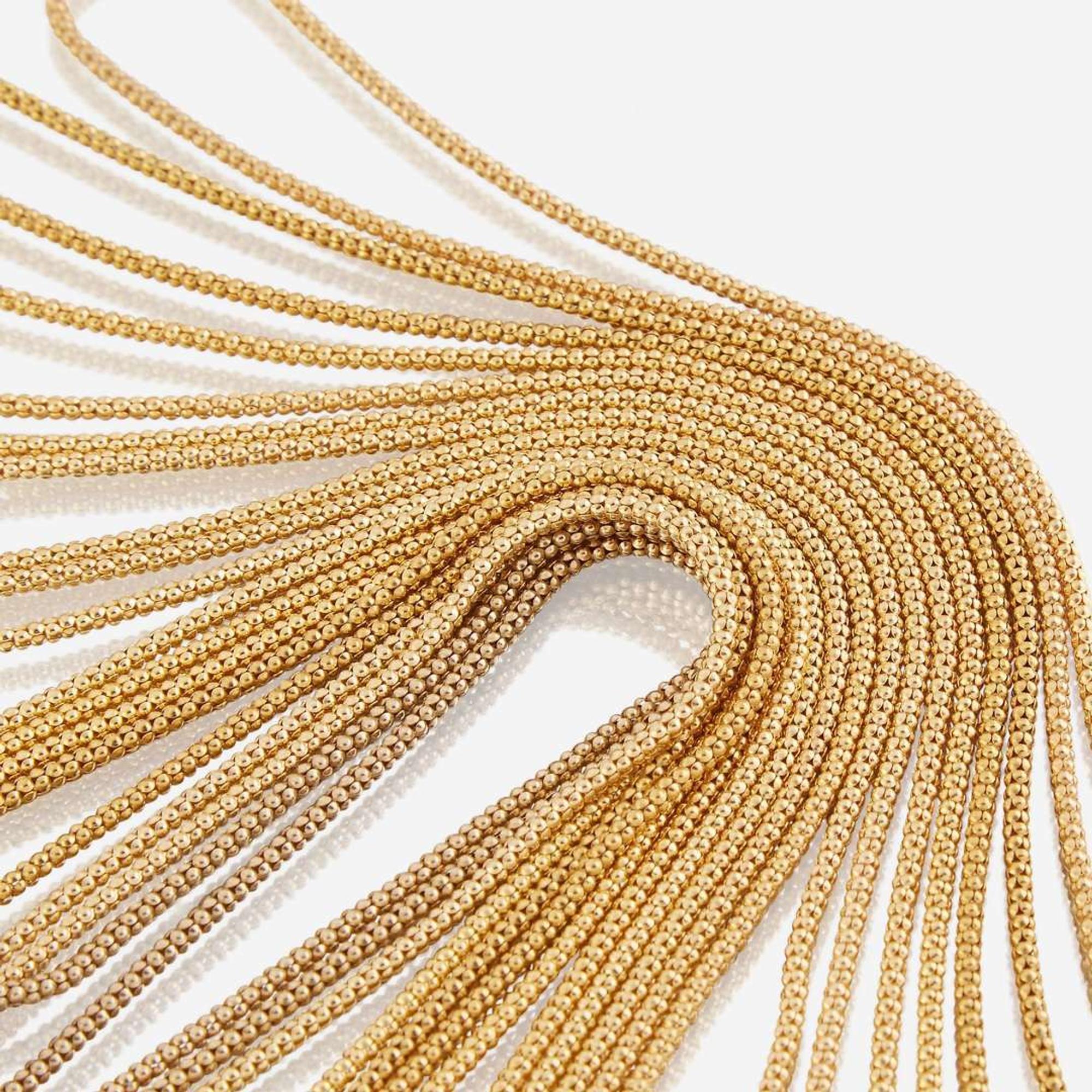 A collection of eleven fourteen karat gold necklaces