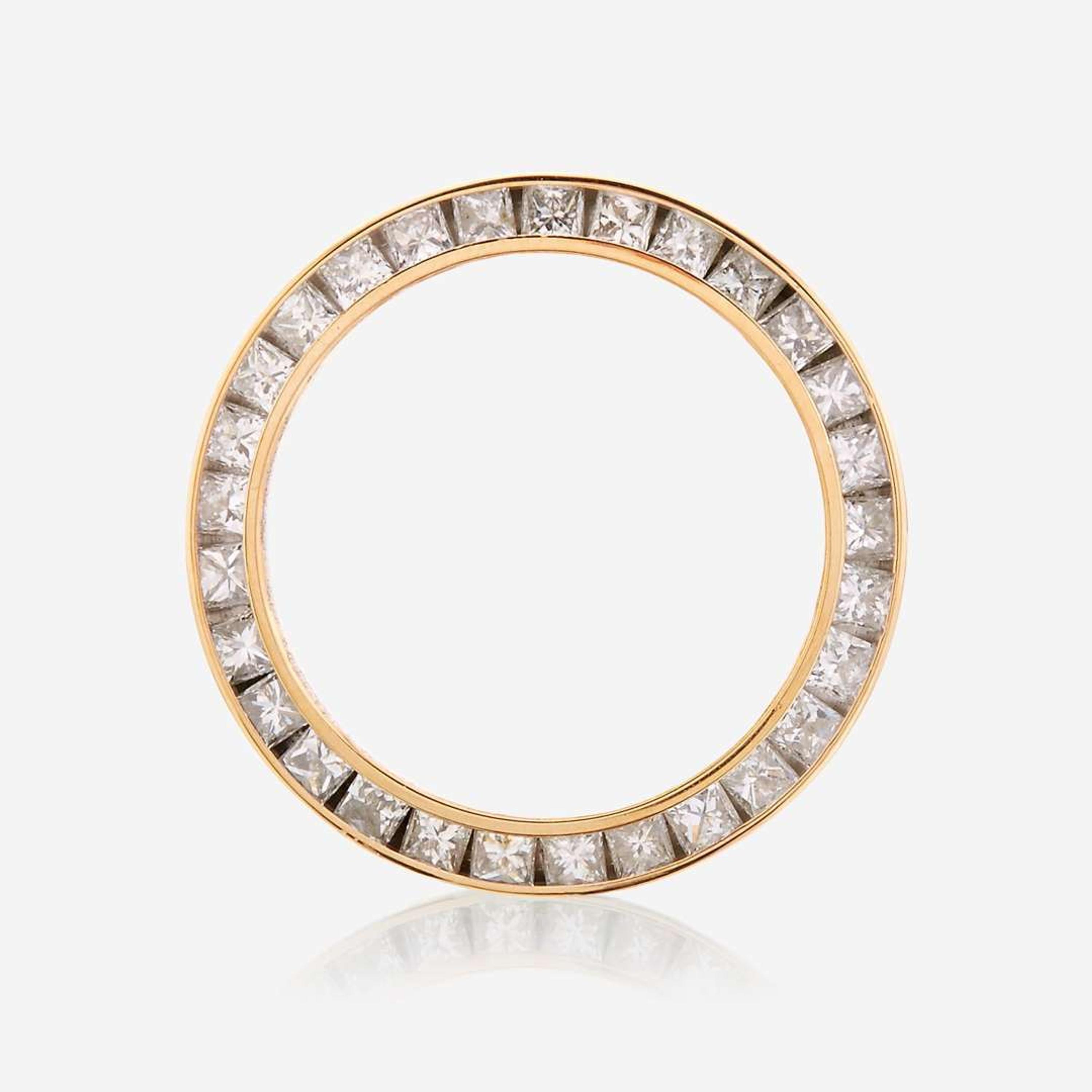 An eighteen karat gold and diamond watch bezel