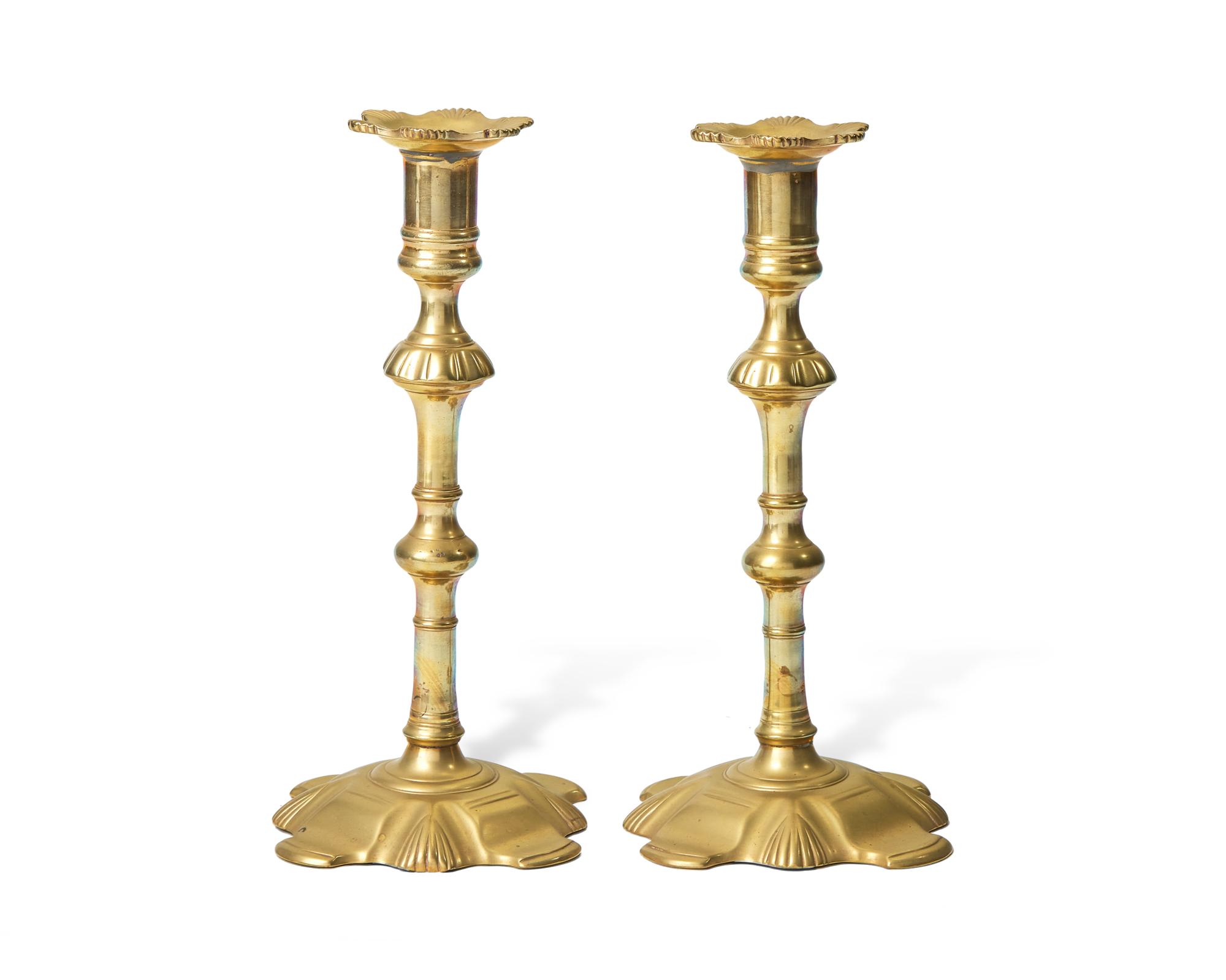 A Group of Four George III Brass Candlesticks