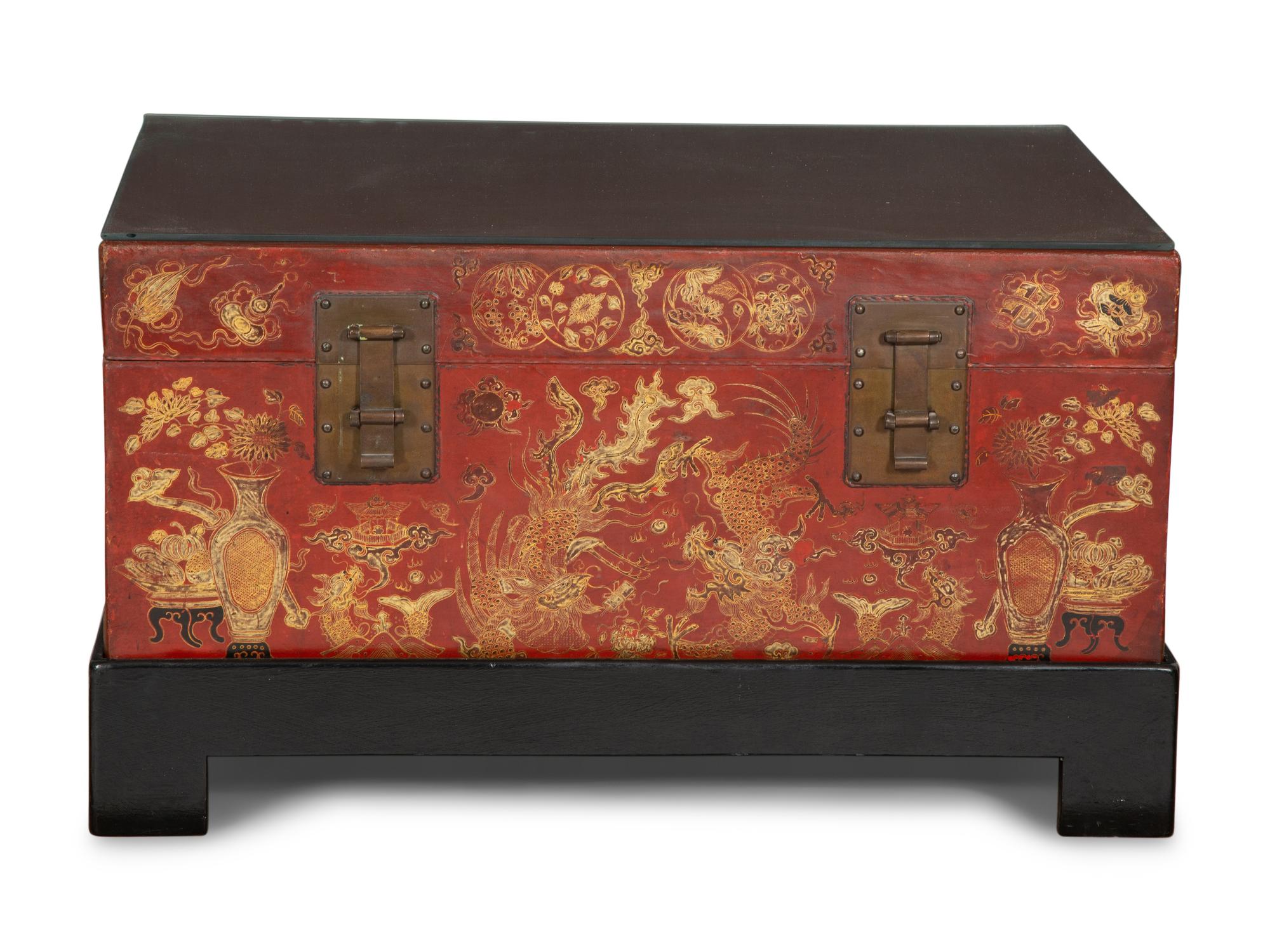 A Chinese Gilt-Decorated Red Leather Trunk on Black Lacquered Stand