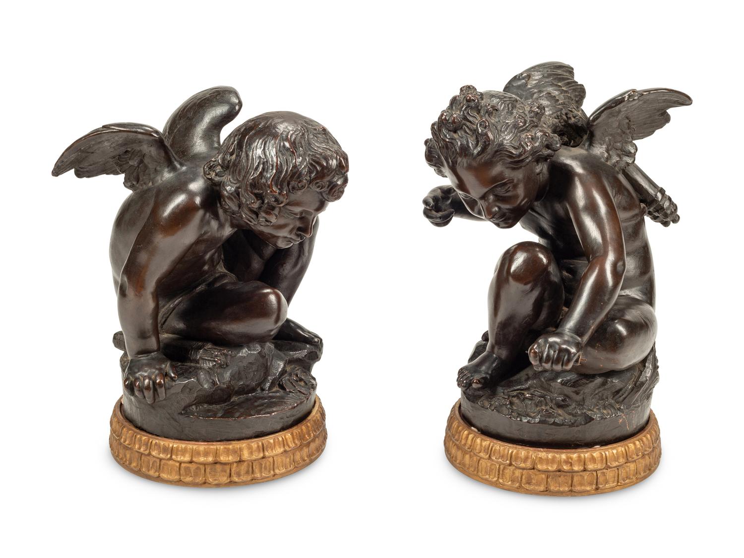 A Pair of Bronzed Composition Figures of Seated Cherubs