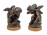 A Pair of Bronzed Composition Figures of Seated Cherubs