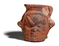 An Egyptian Terracotta Jar with the Head of Bes