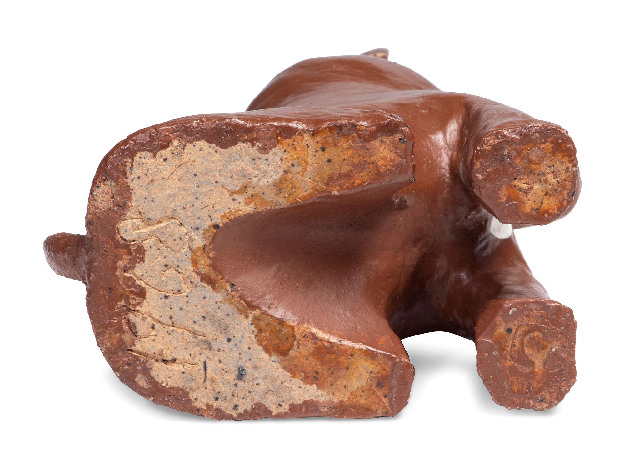 A Glazed Sewer Tile Recumbent Lion Doorstop