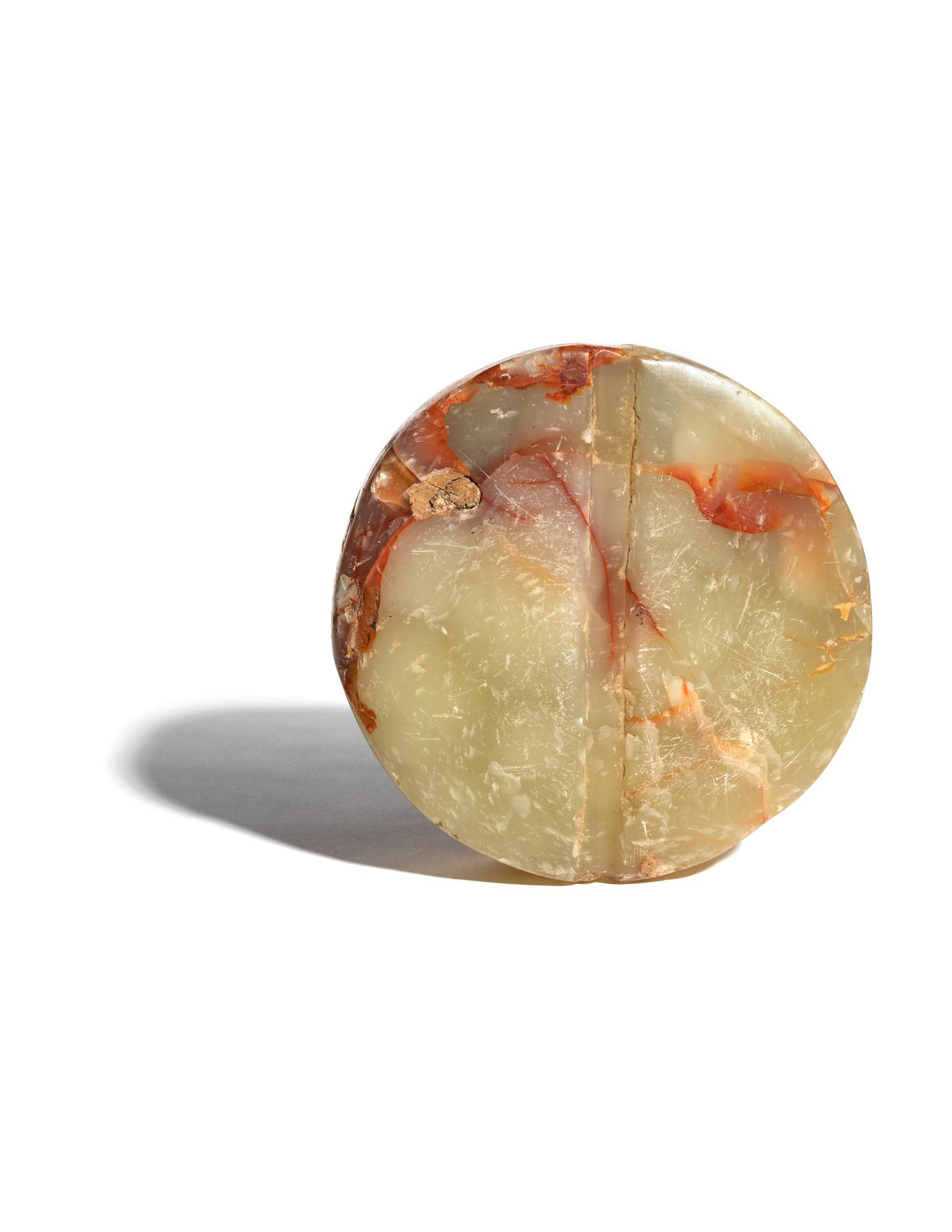 A Bactrian Mottled Green-Orange Stone Disk Ritual Object