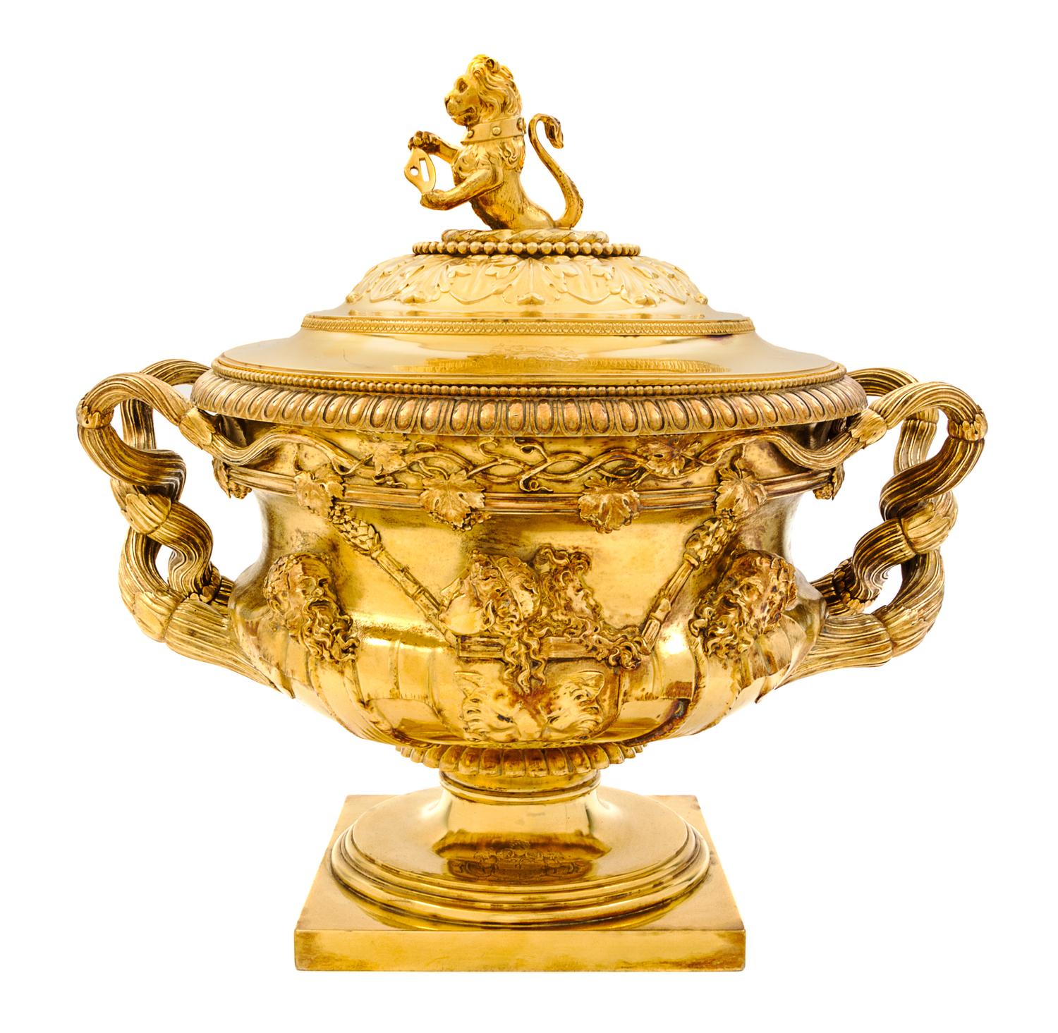 A George III Silver-Gilt Tureen, Benjamin Smith II & Benjamin Smith III, London, 1817, modeled after the Warwick vase, the lid with a l