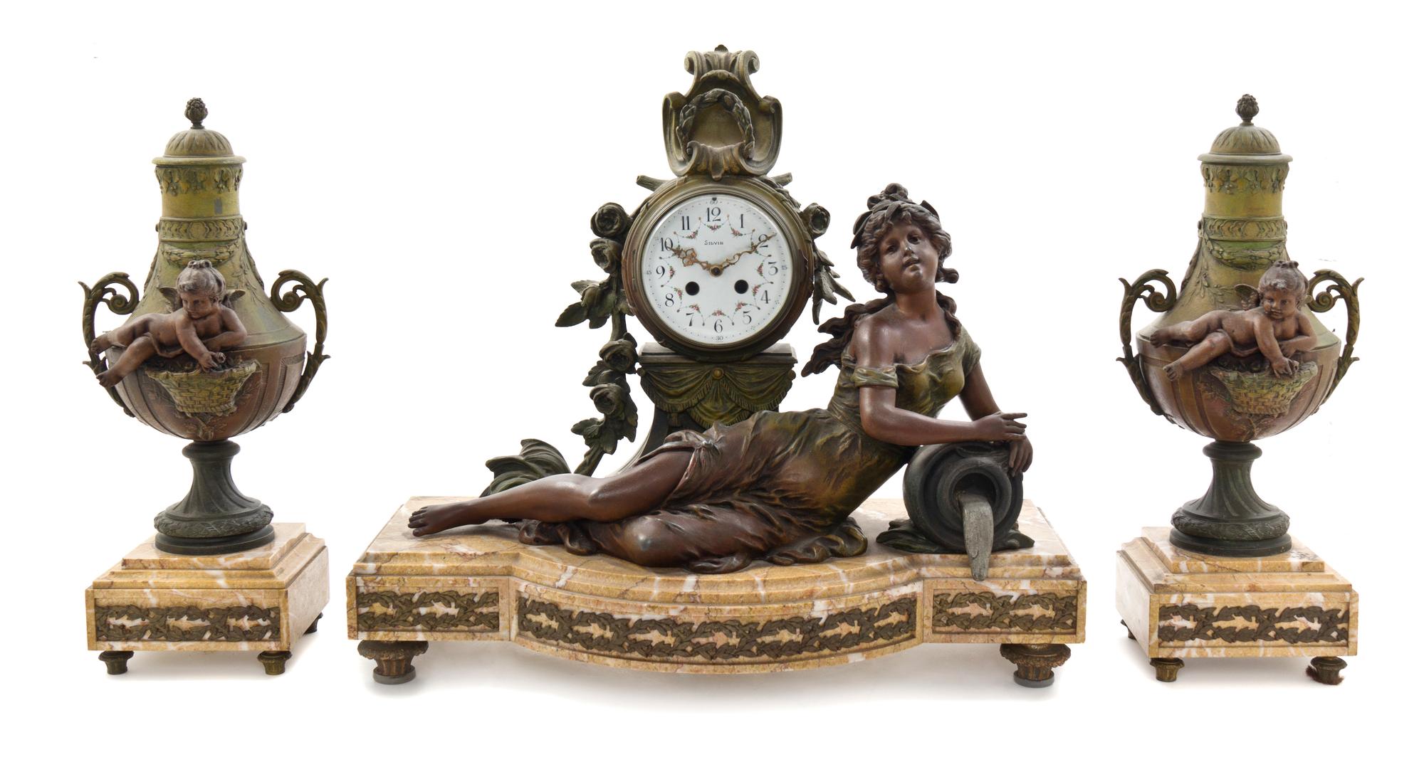 A French Cast Metal and Marble Three-Piece Clock Garniture, Silbin, Width of clock 22 inches.