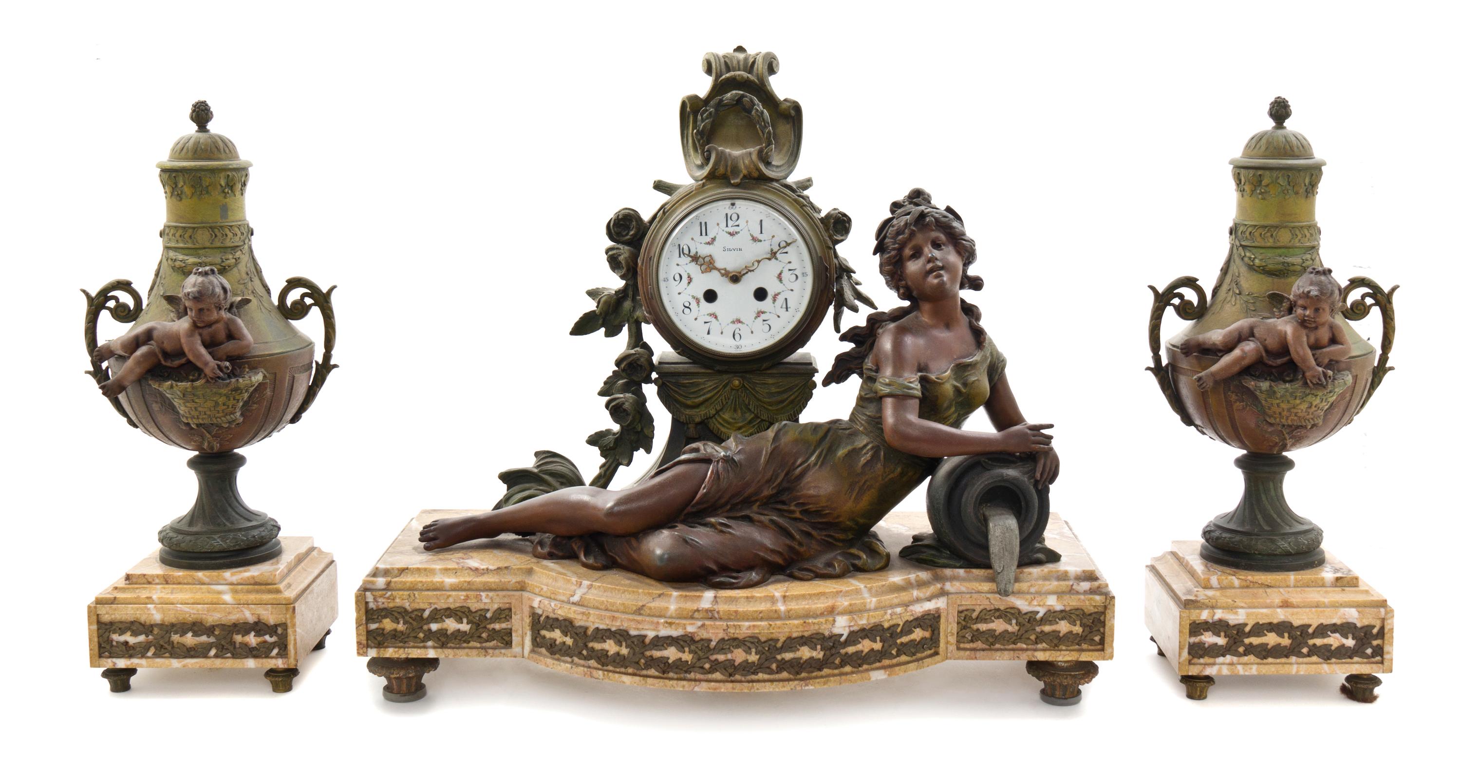 A French Cast Metal and Marble Three-Piece Clock Garniture, Silbin, Width of clock 22 inches.
