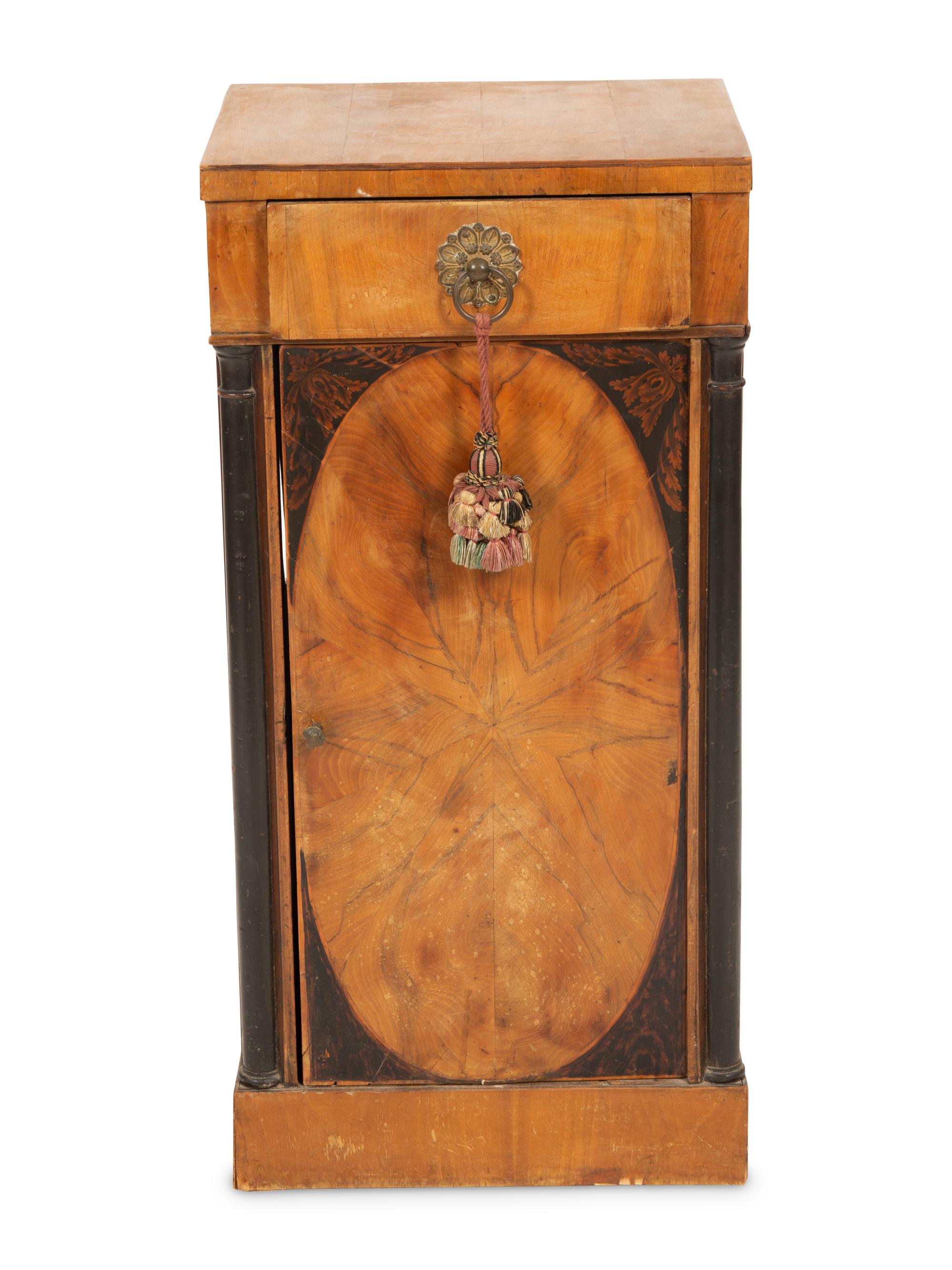 A Northern Italian Walnut and Ebonized Bedside Cabinet