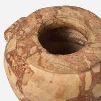 An Egyptian red breccia jar Predynastic Period (Naqada II), circa 3500-2900 B.C.