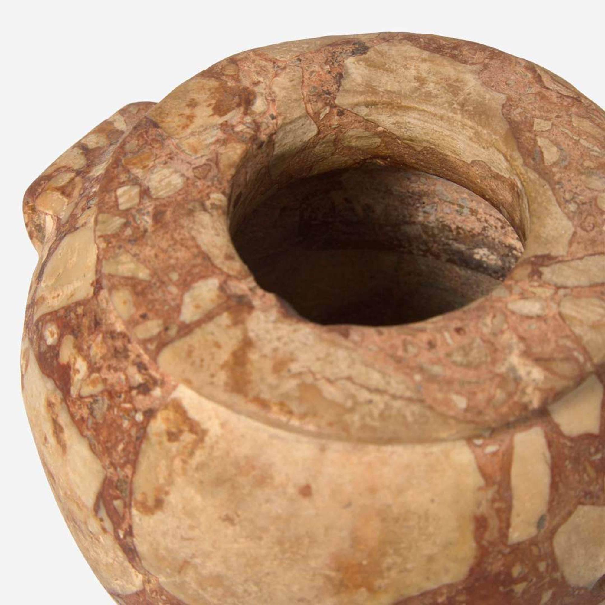 An Egyptian red breccia jar Predynastic Period (Naqada II), circa 3500-2900 B.C.