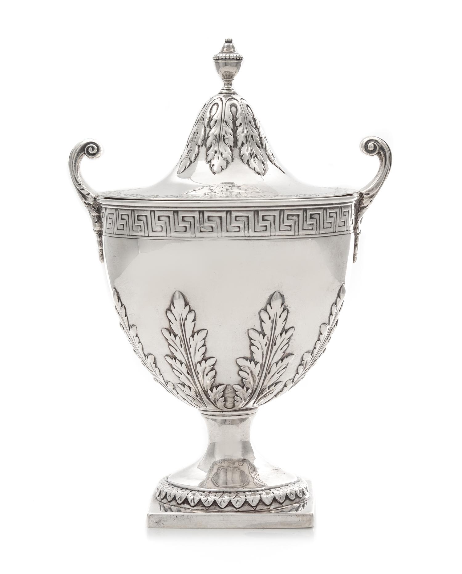 A George III Covered Sugar, Elizabeth Roker, London, 1775, the beaded urn form finial above the acanthus decorated lid, the body with b