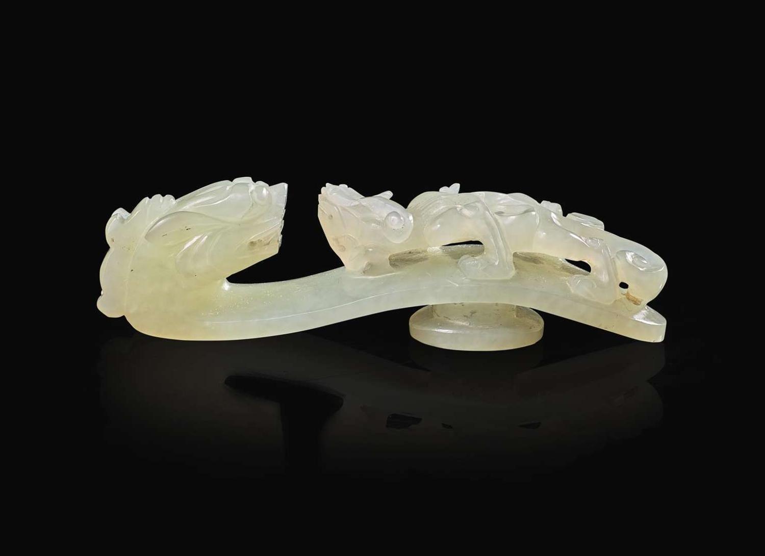 A Chinese carved pale celadon jade belt hook, Qing dynasty 青玉帶鉤 清