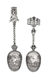 A Group of Two Dutch Silver Serving Spoons, Early 20th Century, each bowl decorated with a village scene with a twist stem surmounted b