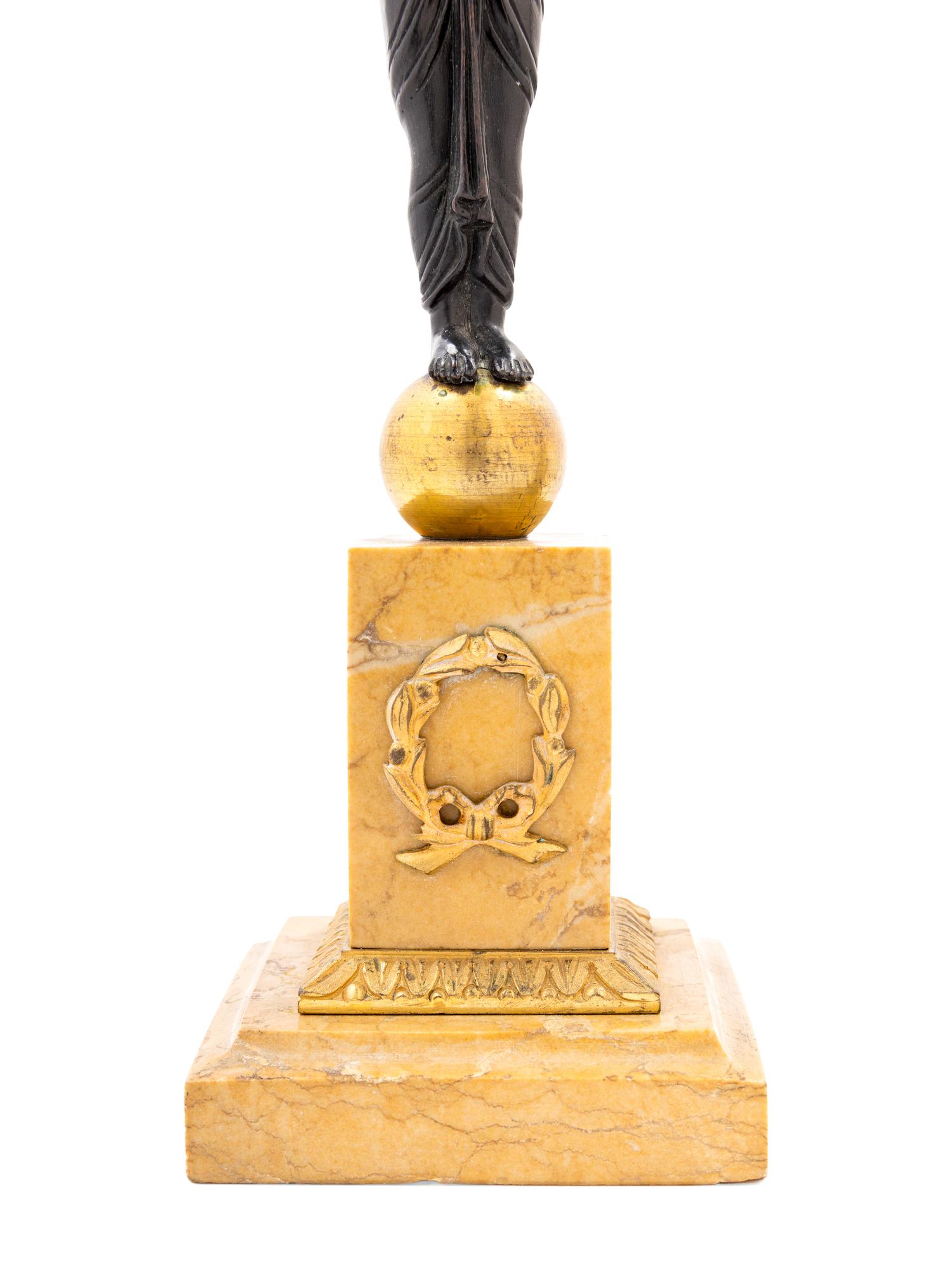 A Pair of French Egyptian Revival Bronze and Marble Candlesticks