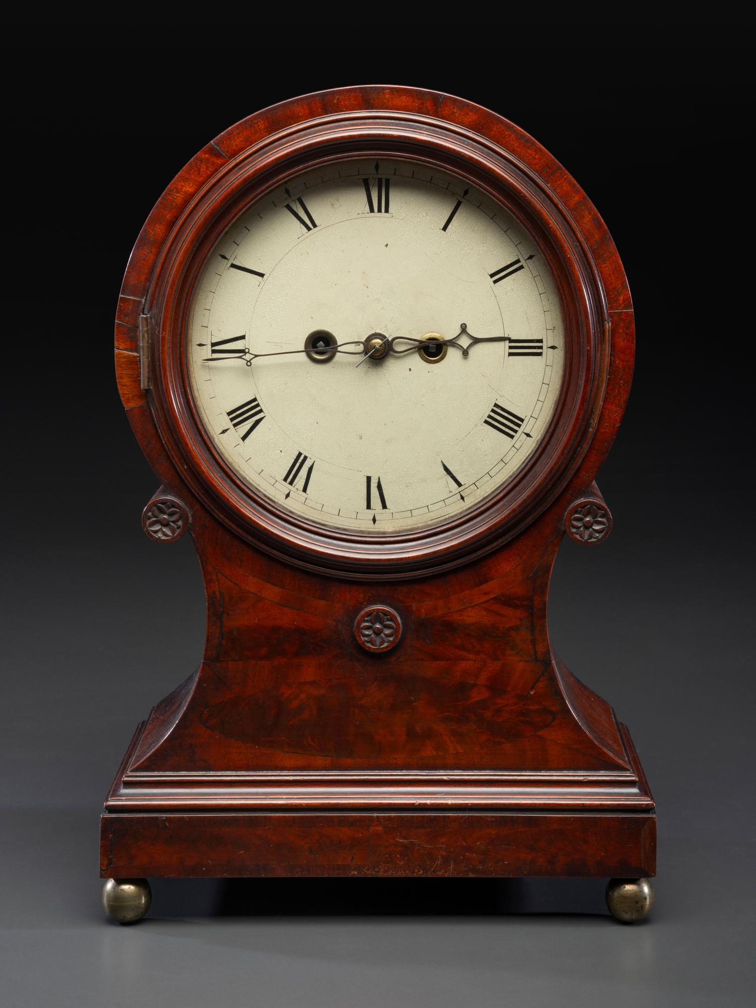 A Federal Carved and Figured Mahogany Balloon-Form Bracket Clock