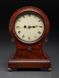 A Federal Carved and Figured Mahogany Balloon-Form Bracket Clock
