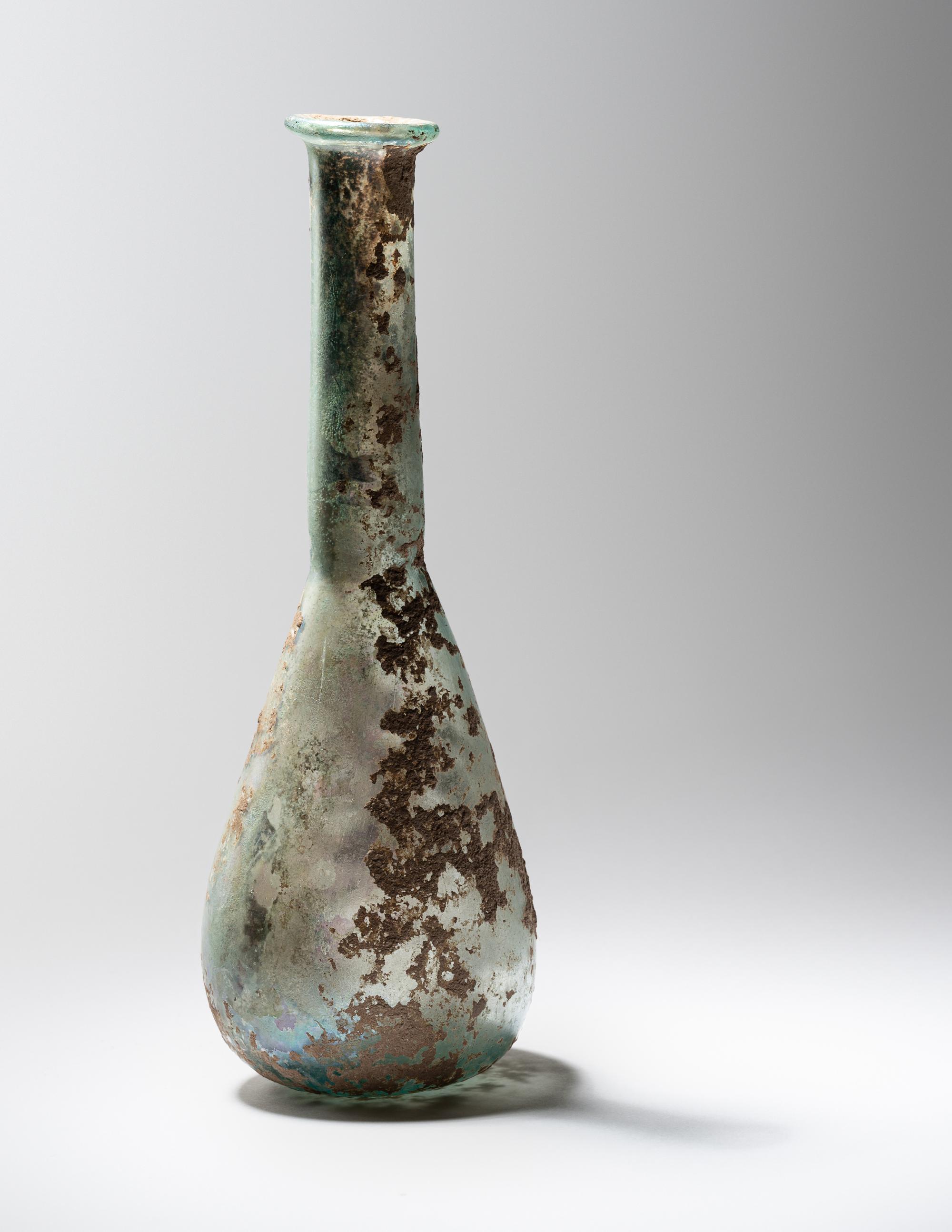 A Roman Pale Blue Glass Unguentarium